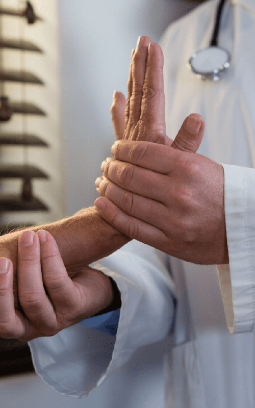 Doctor extending patient's wrist
