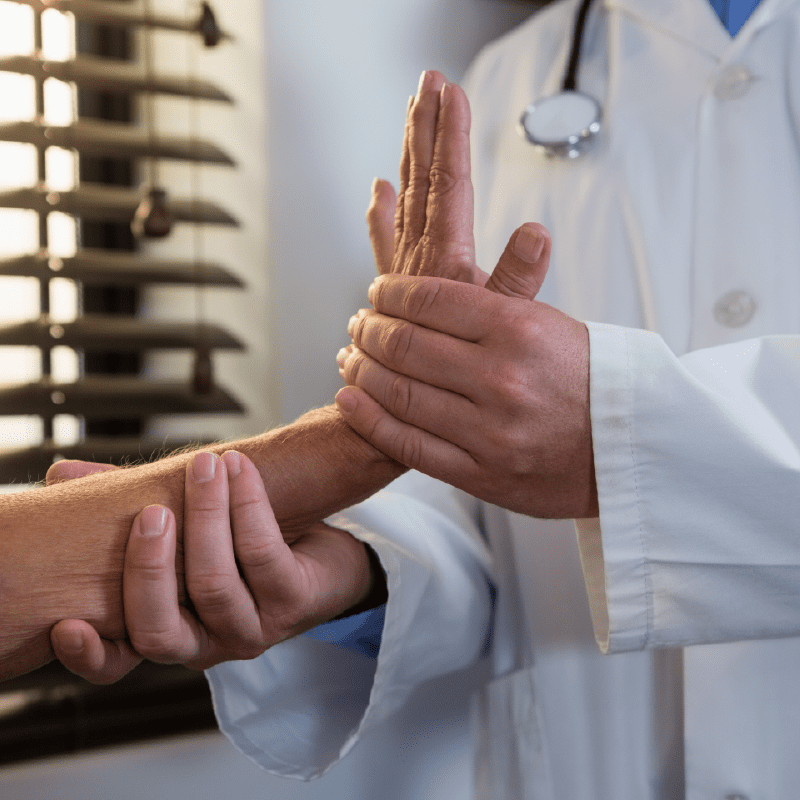 Doctor extending patient's wrist